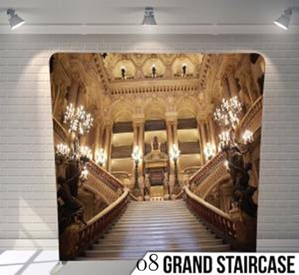 Luxury photo booth backdrop featuring a majestic marble grand staircase with ornate pillars and glowing chandeliers.