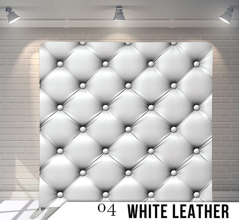 Luxury white leather tufted photo booth backdrop with a classic diamond-stitched Chesterfield pattern.